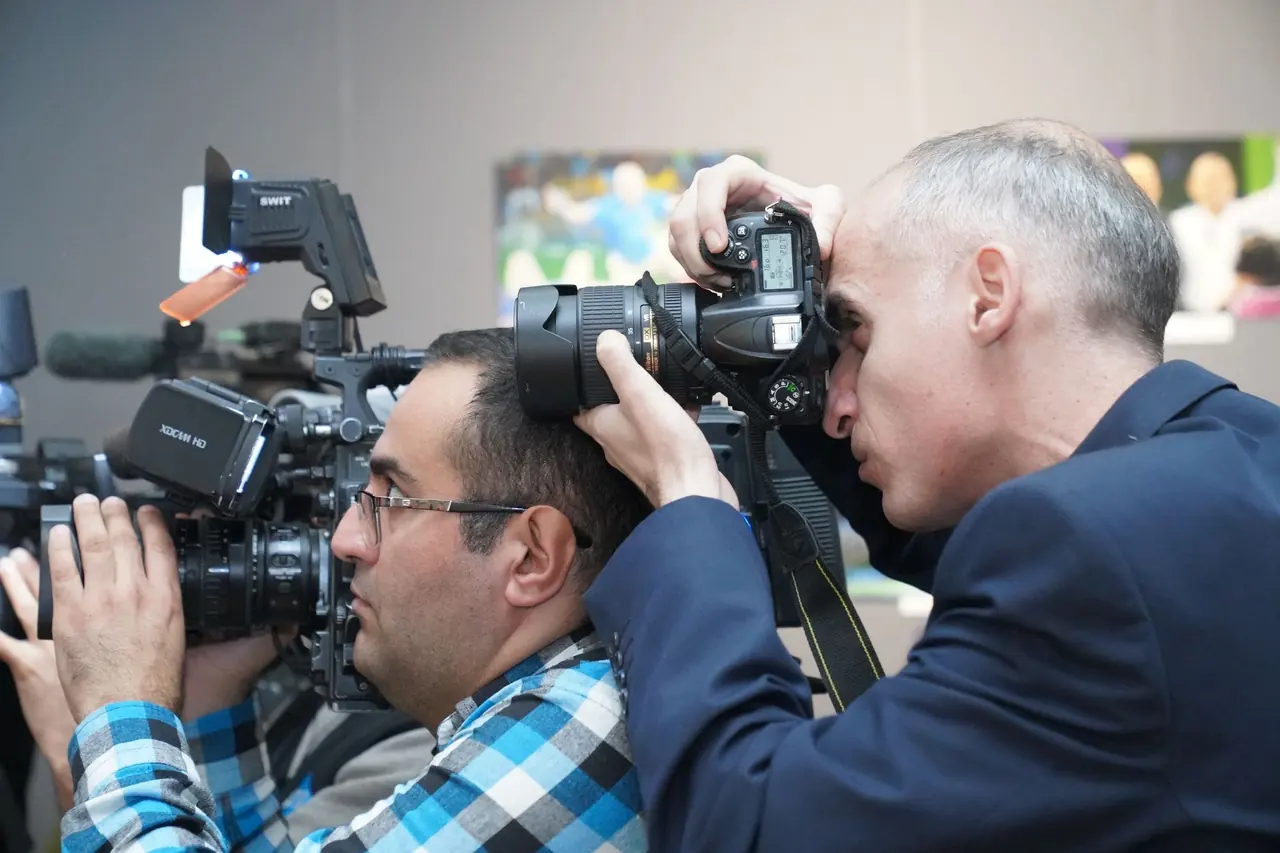 Camera operators filming an event