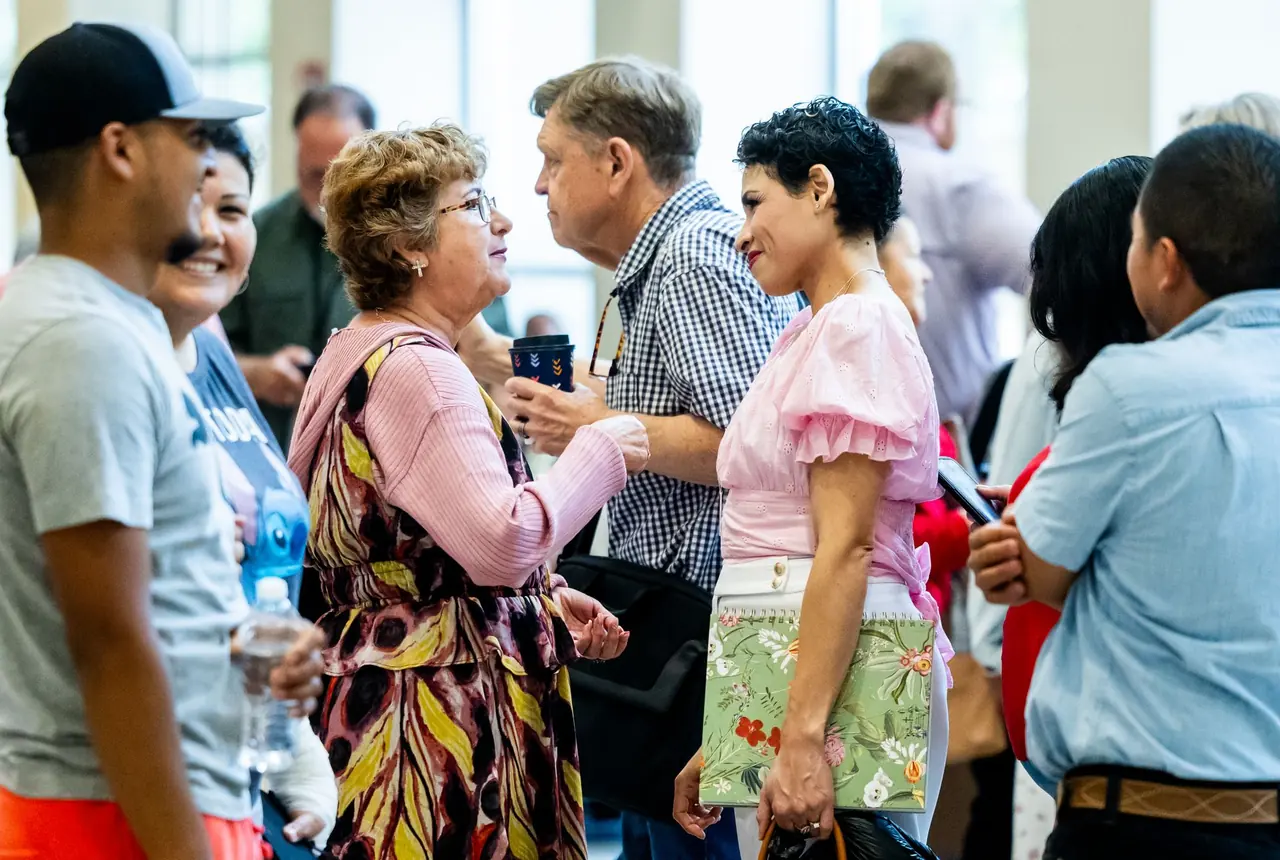 Neighbors talking with one another at a community gathering