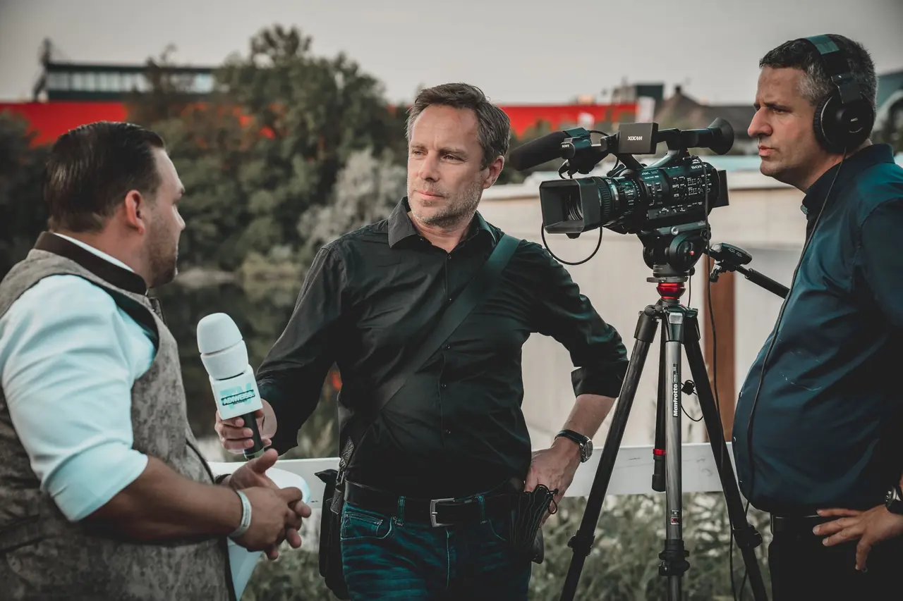 A news crew filming an outdoor interview