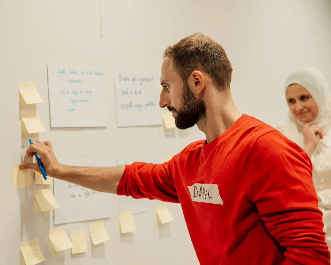 A strategist arranging sticky notes during a planning workshop