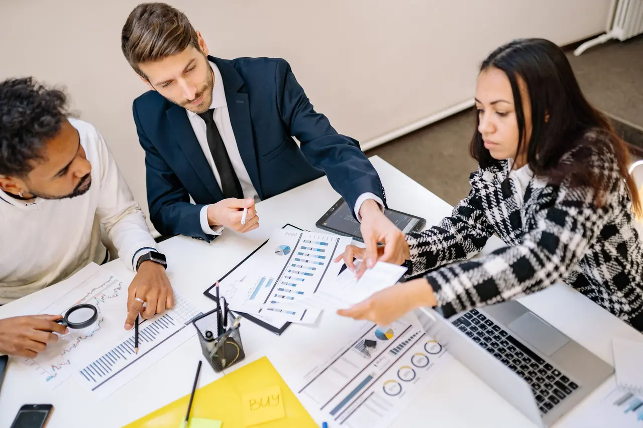 A campaign team working through plans and charts at a table