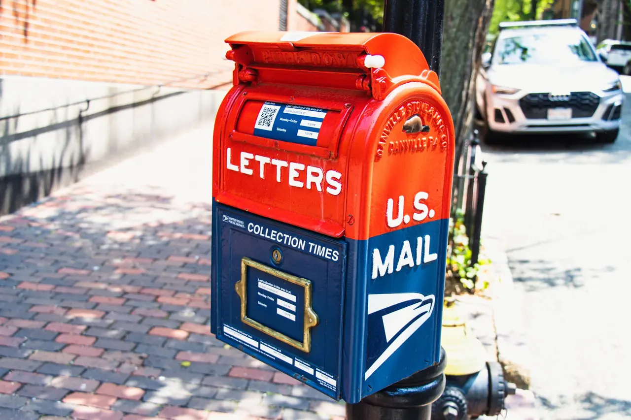 A U.S. Mail collection box on a city sidewalk