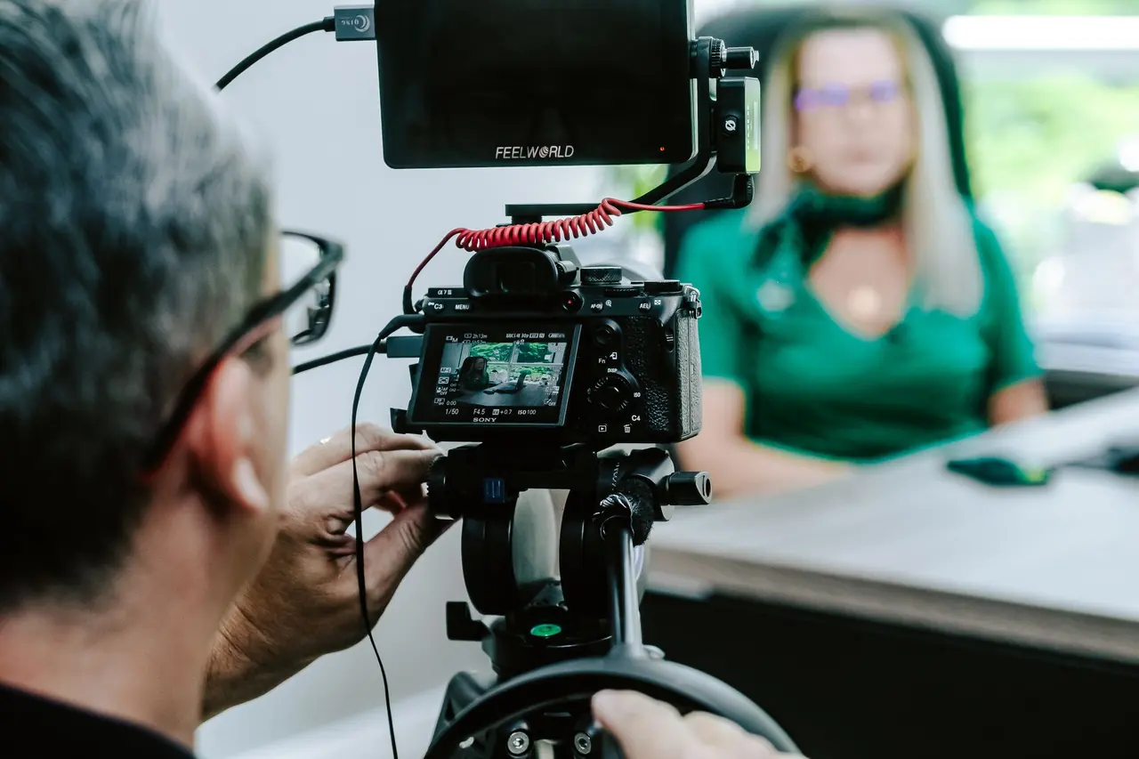 A videographer filming an interview